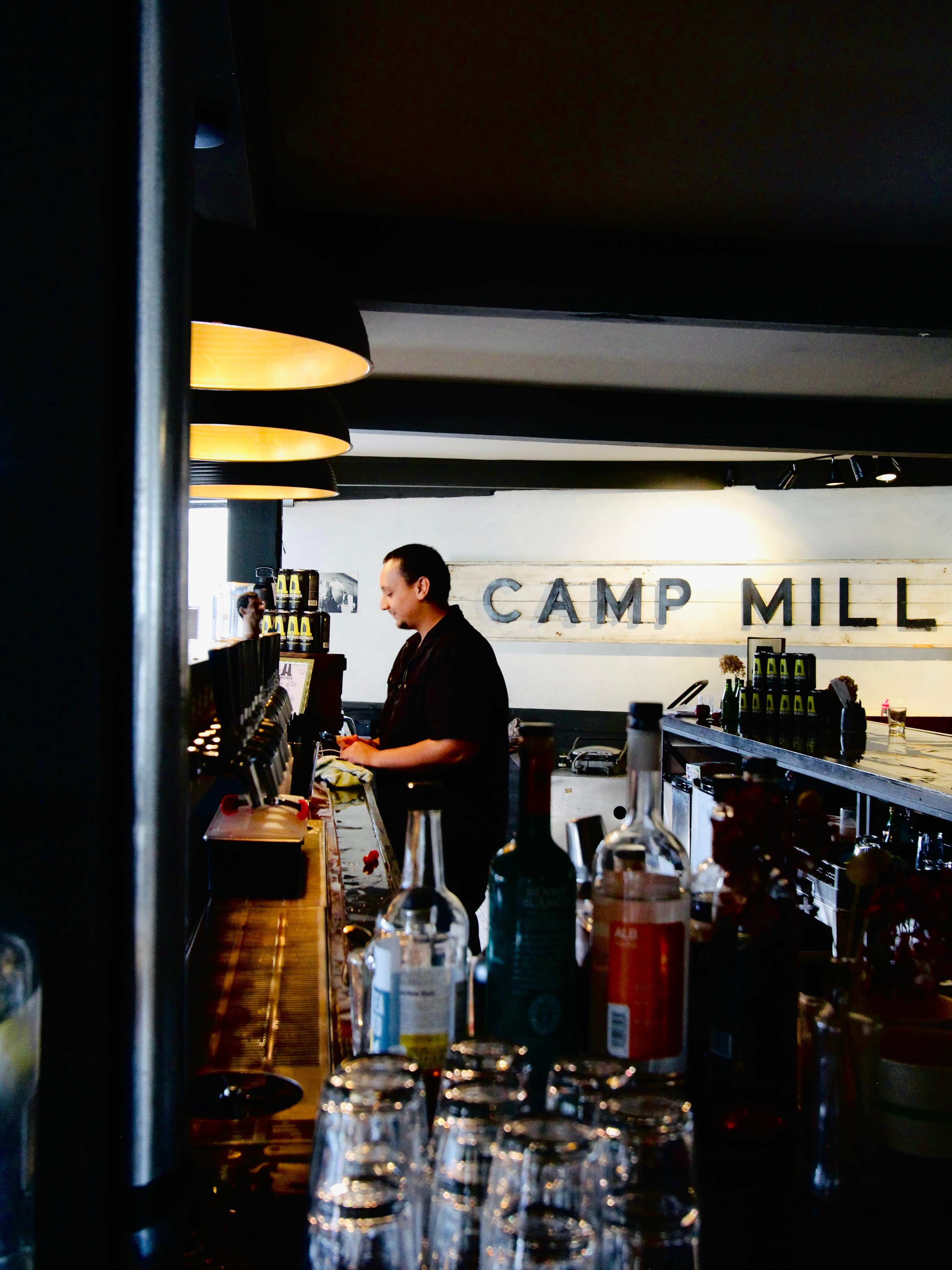Bartender Mario expertly crafts a beverage at the Walton, NY Awestruck Mill location